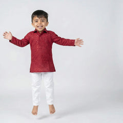 Boy wearing red embroidered kurta with white pajama traditional festive ethnic wear for kids