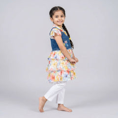 Girl wearing floral layered ruffle dress with denim vest embroidered flower details stylish party wear outfit for kids