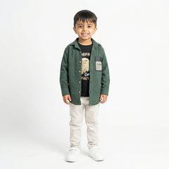 Smiling boy wearing green shirt with printed t-shirt and beige pants stylish kids outfit
