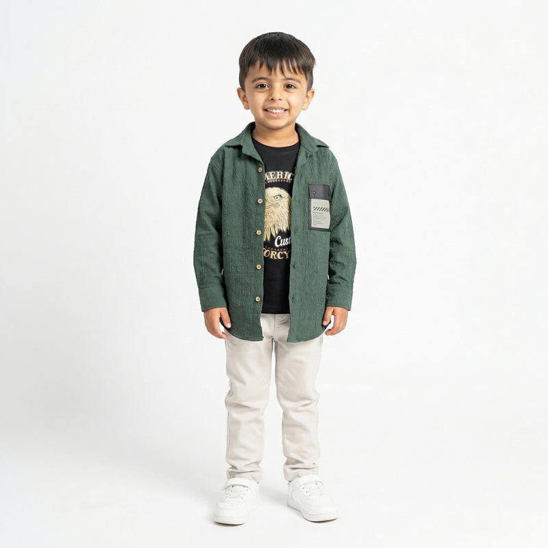 Smiling boy wearing green shirt with printed t-shirt and beige pants stylish kids outfit