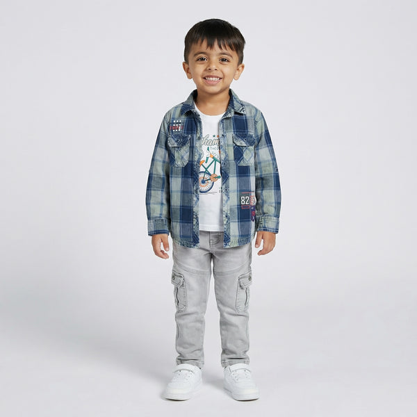 Child wearing a blue plaid shirt, white t-shirt, gray pants, and white sneakers on a light gray background