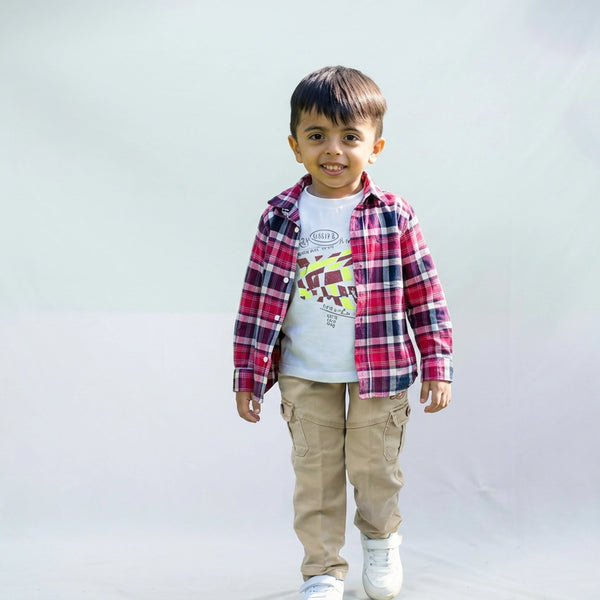 Young boy wearing a checked casual shirt over a graphic T-shirt, cargo pants, and white sneakers, shown in two color variants against a plain light background.