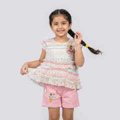 Girl wearing pastel printed ruffle top with pink shorts cute summer outfit for kids stylish casual co-ord set for girls