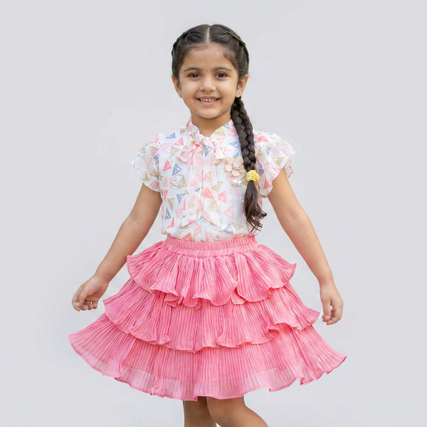 Little girl wearing pink pleated layered skirt with printed flutter sleeve top stylish kids party wear outfit