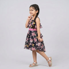Girl wearing black floral printed halter neck dress with pink waist belt stylish kids party wear dress with flowy skirt