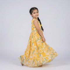Young girl wearing a yellow floral dress on a white background