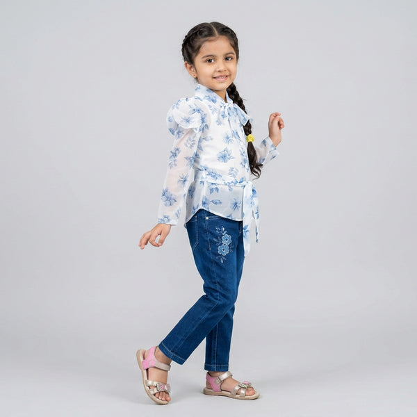 Little girl wearing white floral printed shirt with blue denim jeans and belt stylish casual outfit for kids