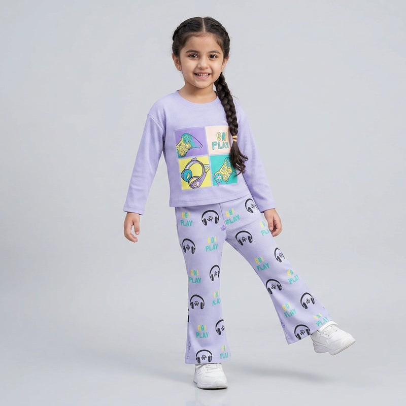 Little girl wearing graphic sweatshirt and matching printed flared pants co-ord set casual outfit for kids