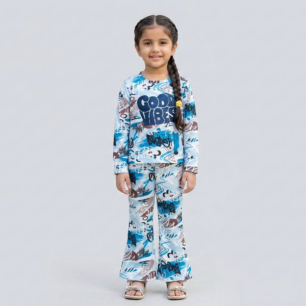 Little girl wearing white and blue graphic printed co-ord set with full sleeve top and matching pants for kids casual wear