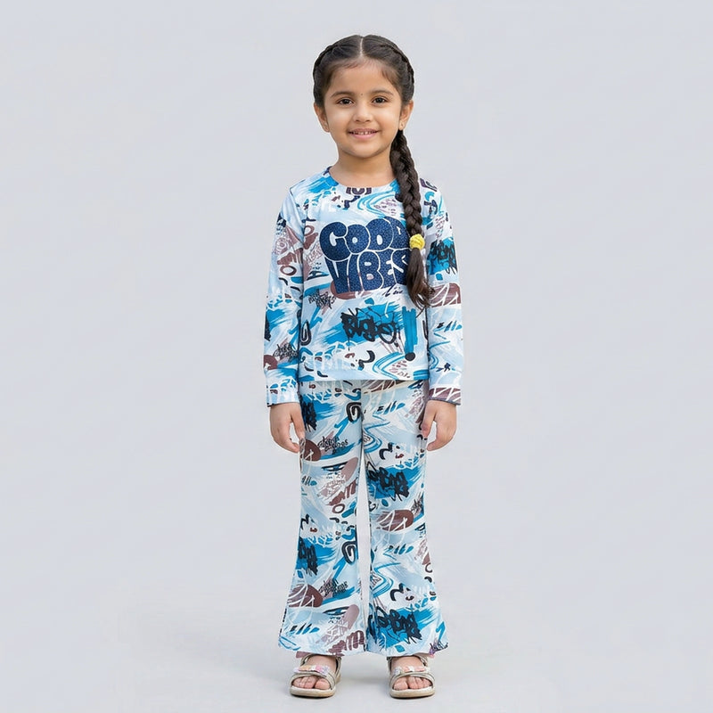 Little girl wearing white and blue graphic printed co-ord set with full sleeve top and matching pants for kids casual wear