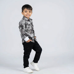 Young boy wearing abstract printed shirt with black jeans stylish kids casual outfit