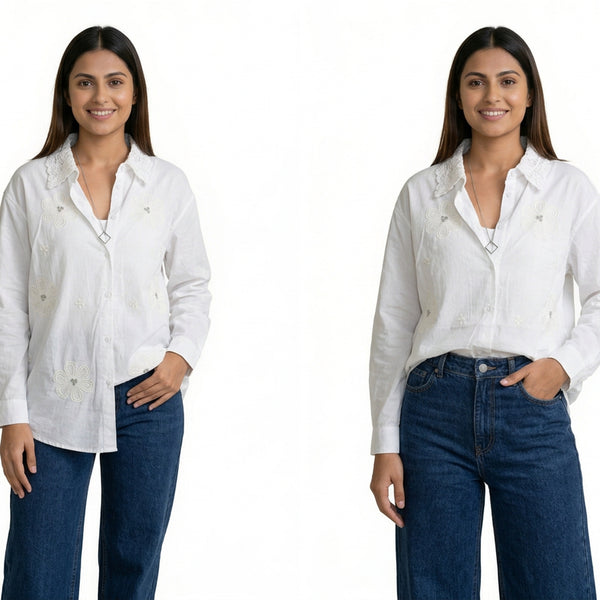 A woman wearing a white button-down shirt with subtle floral embroidery and a textured collar, paired with blue jeans.