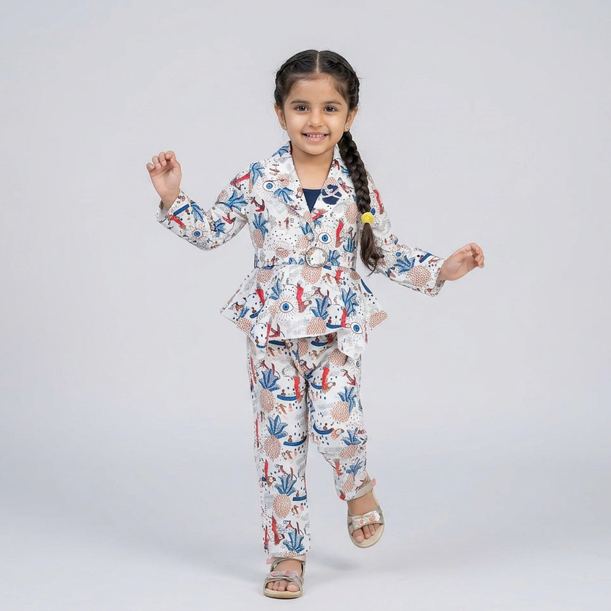 Girl wearing printed peplum co-ord set with blazer style top and matching pants stylish party wear outfit for kids