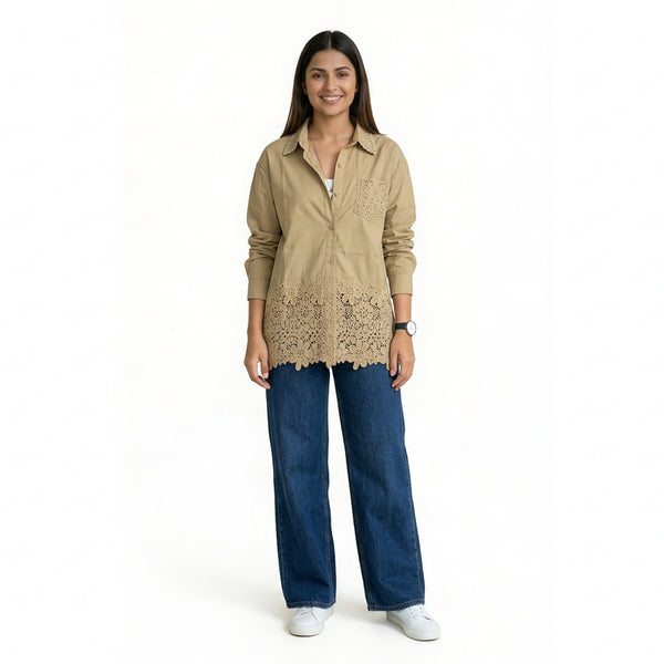 Women’s beige pink button-down shirt with lace hem detailing, long sleeves, and a relaxed fit, styled with blue wide-leg jeans and white sneakers.