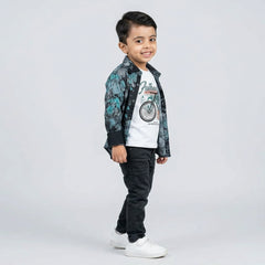 Young boy wearing dark printed shirt with graphic t-shirt and grey jeans kids 3 piece casual outfit
