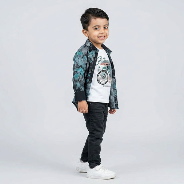 Young boy wearing dark printed shirt with graphic t-shirt and grey jeans kids 3 piece casual outfit