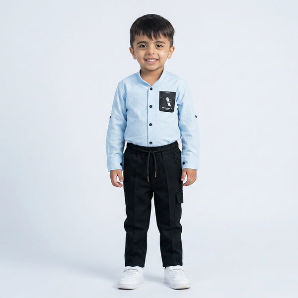 Young boy wearing light blue shirt with graphic t-shirt and black jogger pants kids casual 3 piece outfit