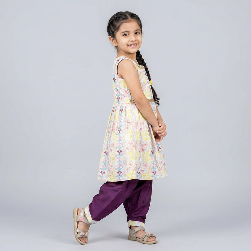 Young girl wearing a floral dress and purple pants - ethnic dress for girls