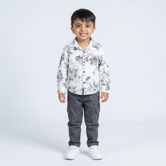 Young boy wearing white floral printed shirt with grey cargo pants smart casual kids outfit