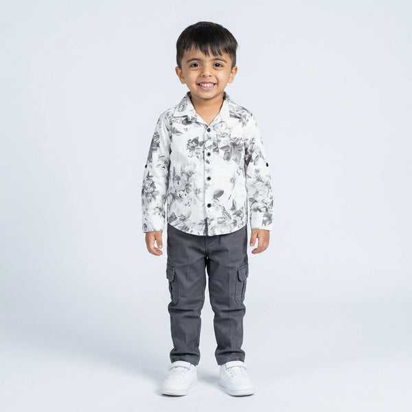 Young boy wearing white floral printed shirt with grey cargo pants smart casual kids outfit
