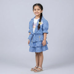 Girl wearing blue gingham check co-ord skirt set with ruffle sleeves and tie front top stylish party wear outfit for kids
