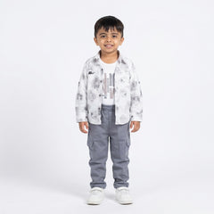 Child wearing a white patterned shirt and gray pants on a white background