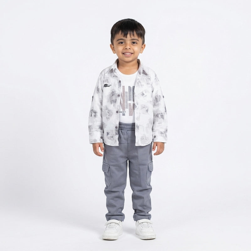 Child wearing a white patterned shirt and gray pants on a white background