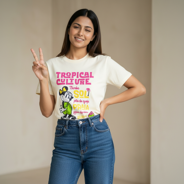 Woman wearing a white t-shirt with colorful graphics and text, making a peace sign.