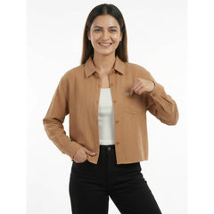 Woman wearing a brown shirt over a white inner on a white background