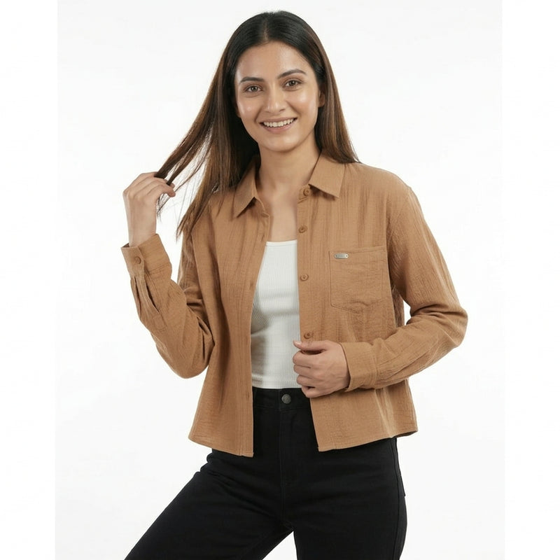 Woman wearing a brown shirt over a white shirt on a white background