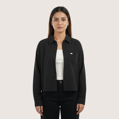 Woman wearing a black shirt over a white shirt on a white background