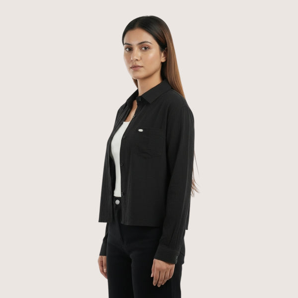 Woman wearing a black shirt over a white shirt on a white background